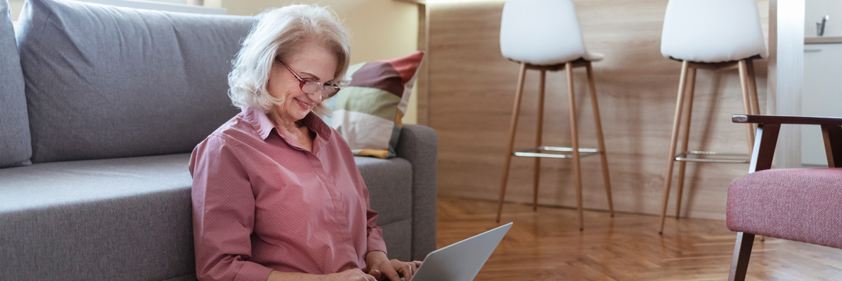 Older woman typing on a laptop