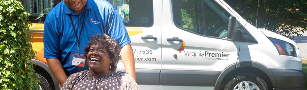 Virginia Premier employee pushing woman in wheelchair