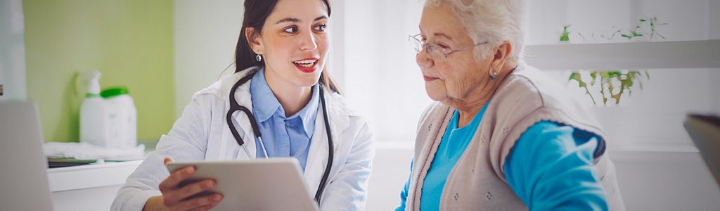 doctor talking to elderly patient